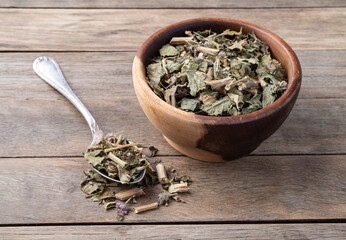 Lemon balm or Melissa dried tea leaves on a bowl over wooden table