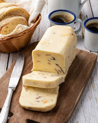 Requeijao de corte, traditional brazilian country cream cheese with coffee and bread over wooden table
