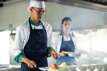 Cooking class. portrait asian thai male professional chef cooking meal. culinary classroom. cooking...