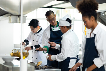 Group of student learning. Cooking class. culinary classroom. group of happy mature man and young woman multi - ethnic students are focusing on cooking lessons in a cooking school.