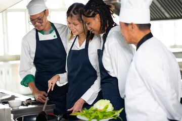 Group of student teen girl learning. Cooking class. culinary classroom. group of happy young woman multi - ethnic students are focusing on cooking lessons in a cooking school.