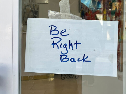 BE RIGHT BACK sign in a store window