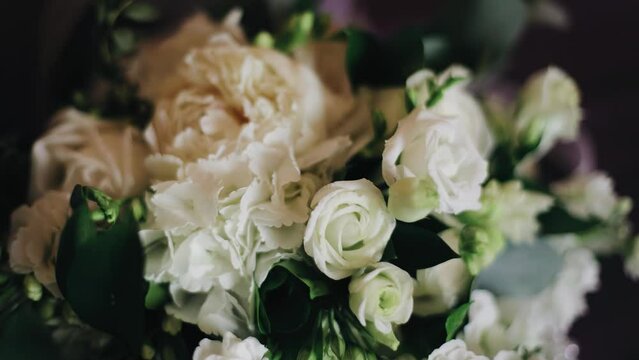 A close-up of a bouquet of fresh flowers lying on the table. Very smooth camera movement