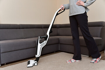 Woman cleaning the living room with vacuum cleaner