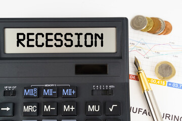 On the table are financial reports, coins and a calculator with the inscription - Recession