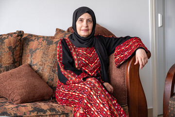 Female wearing palestinian traditional clothes indoor