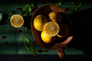 Photo of Lemon, a Storehouse of Vitamin C for the Winter Months on a Green Wooden Background,...