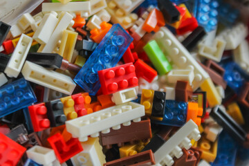 pile of colorful Lego blocks. Top angle view of lego bricks on white background - obrazy, fototapety, plakaty
