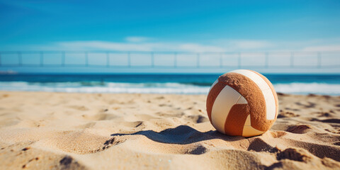 Obraz premium Beach volleyball sits on the sand, inviting a game at a sunny seaside court