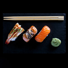 Sushi on black plate and black background
