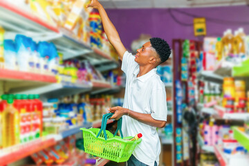 Man Holding Plastic Shopping Basket in Grocery Store