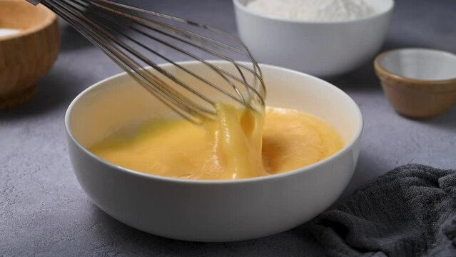 whisking eggs with a whisk. Cooking omelette or baking pastry. Protein food. 