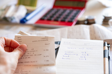 hands holding money from point of view in front of Table consist of money bills and medicine...