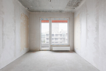 interior of the apartment without decoration in gray colors. rough finish