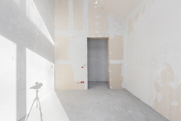 interior of the apartment without decoration in gray colors. rough finish