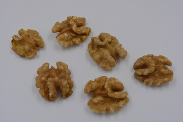 Healthy food, natural nuts, walnuts arranged on a white background.