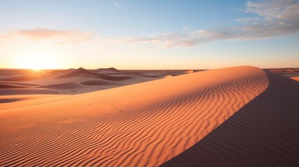 Fototapeta na wymiar Desert dunes casting long shadows as the sun sets in the distance