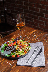 salad with grilled vegetables, roast beef on a black plate, dark and moody, top new