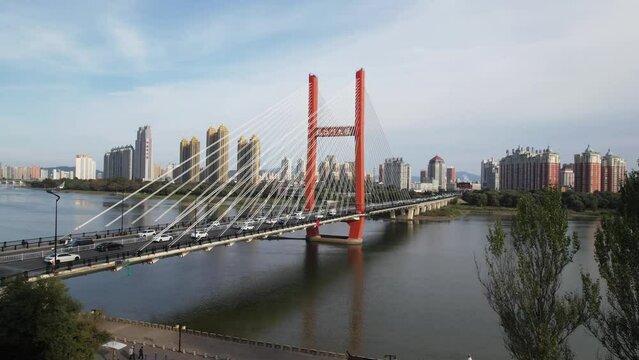 view of suspension bridge over river and city
