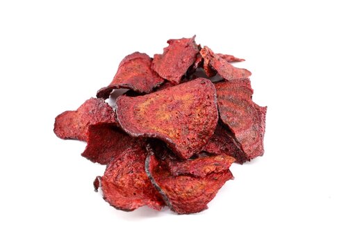 Heap of red beet chips on white background.