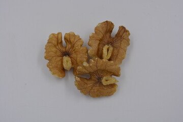 Healthy food, natural nuts, walnuts arranged on a white background.
