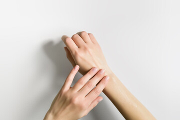 a woman applies a cosmetic cream to her hands. hand skin care concept