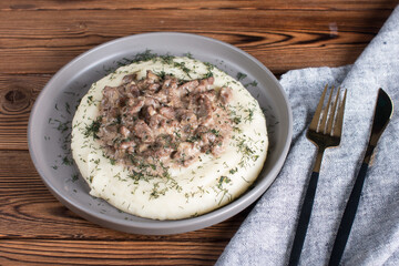 beef stroganoff with mashed potatoes on a plate. Serving a hot meat dish