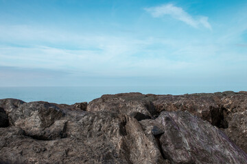 Stone rocky shore against the backdrop of the sea ocean. Summer mood