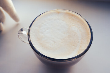  The Barista made cappuccino and drew a picture on the foam of the coffee.