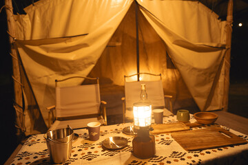 Showcasing the spacious interior of a luxury camping tent with comfortable furnishings, and outdoor...