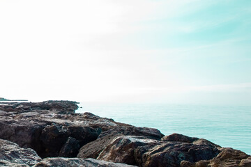 Stone rocky shore against the backdrop of the sea ocean. Summer mood