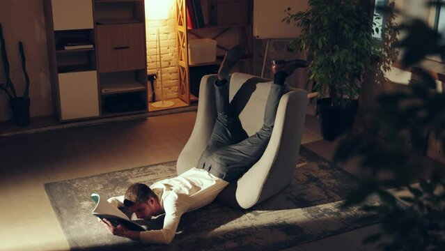 Businessman falling down armchair while reading documents. Office worker feeling tire and exhausted. Concept of business, working routine, deadlines, freelance, office, ad