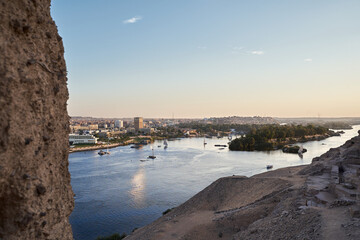 Sunset over the Nile River in the city of Aswan with sandy and deserted shores