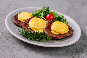 Meatballs or cutlets with tomato and cheese