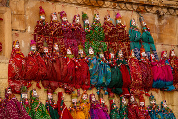 Fototapeta premium Indian market scene from the streets of Rajasthan selling handcrafted Kathputli or string puppet 