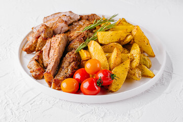 Grilled kebab pork meat with roasted potato and vegetables