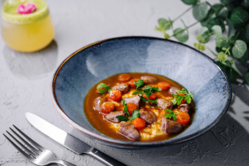 Traditional goulash with mashed potatoes and herbs
