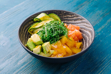 poke bowl with salmon on wood