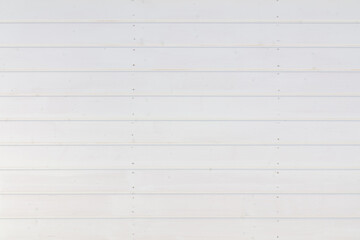 Minimalist white wooden siding, lined with subtle imperfections and gentle shadows, offers a...