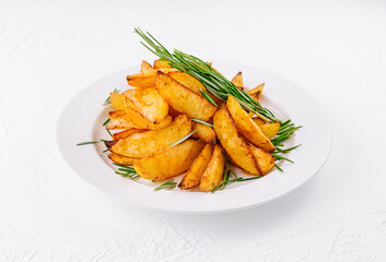 Baked potato wedges with rosemary on plate