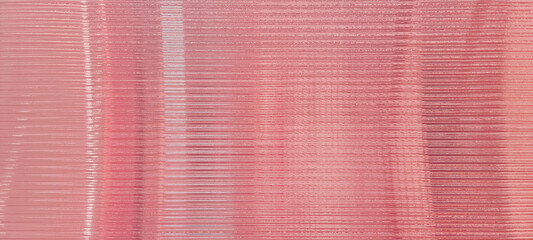 pink glass sheet wall or corrugated wall pattern texture use as background. frosted rose gold wave glass in horizontal line pattern in the translucent and polished effect. Valentines concept.
