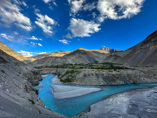 River landscape in the mountains with vibrant blue sky with clouds