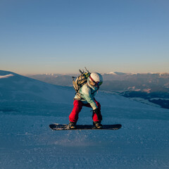 Young woman on the snowboard