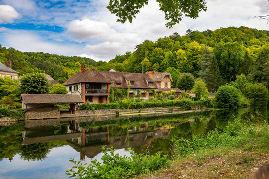 old french house in the greenery near the Iton river in Normandy