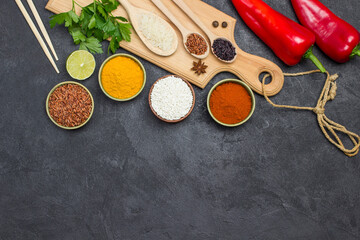 Different types of rice and spices. Wooden cutting board. Raw Red Pepper