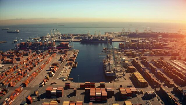 Cargo containers in busy port. Aerial view from drone of Container , container ship in export and import business and logistics. Shipping cargo to harbor,global transportation. 