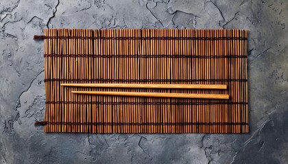 Bamboo mat and chopsticks on gray stone background for your own design of Asian food concept, Bamboo mat and chopsticks on gray stone background