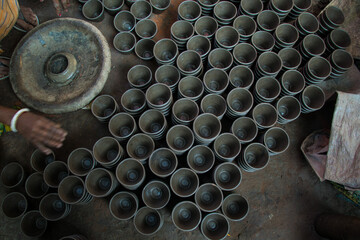 Pottery making involves shaping clay by hand, using a wheel, or coiling techniques.
