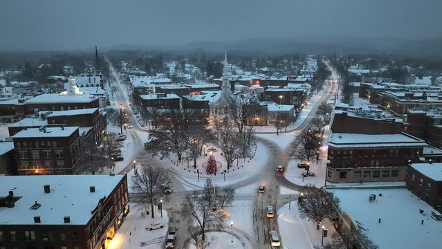 Aerial drone footage of small city in New England at dusk after snowstorm. Filmed in Keene, New Hampshire.