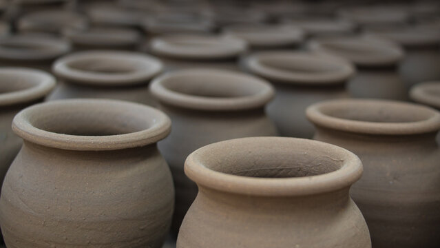 Pottery making involves shaping clay by hand, using a wheel, or coiling techniques.